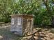 Exterior shed surrounded by lush greenery, offering functional storage and organization at 439 Sw Shorewood Dr, Dunnellon, FL 34431