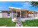 View of the back porch with screened-in patio, open door and tiled walkway at 4757 Nw 45Th Ct, Ocala, FL 34482