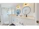 Modern bathroom with double sinks, marble countertop, and a glass-enclosed shower at 4757 Nw 45Th Ct, Ocala, FL 34482