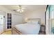 A comfortable bedroom with a ceiling fan, large windows, and plenty of natural light at 4757 Nw 45Th Ct, Ocala, FL 34482