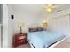 This bedroom includes a ceiling fan, closet, and a wooden nightstand next to the bed at 4757 Nw 45Th Ct, Ocala, FL 34482