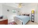 This bedroom features a ceiling fan, and a comfortable bed with bright natural light at 4757 Nw 45Th Ct, Ocala, FL 34482