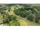 Aerial view of a golf course near a home in a serene, green neighborhood at 5326 Nw 76Th Ct, Ocala, FL 34482