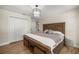 Bedroom featuring hardwood floors, a striking light fixture, and a spacious closet at 5326 Nw 76Th Ct, Ocala, FL 34482