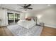 Bedroom with a ceiling fan, en-suite patio access, and stylish neutral-toned decor at 5326 Nw 76Th Ct, Ocala, FL 34482