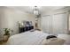 Bedroom with a stylish light fixture, hardwood floors, and double door closet at 5326 Nw 76Th Ct, Ocala, FL 34482