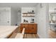 Coffee bar area with wood cabinets, marble countertops and decorative shelving and decor at 5326 Nw 76Th Ct, Ocala, FL 34482