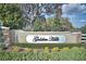 Golden Hills community sign, framed by lush greenery and elegant stone pillars at 5326 Nw 76Th Ct, Ocala, FL 34482