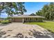 This home features a large parking area, a well-maintained yard, and a fenced property at 5326 Nw 76Th Ct, Ocala, FL 34482