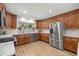 Bright kitchen boasts stainless steel appliances, wood cabinets and marble countertops at 5326 Nw 76Th Ct, Ocala, FL 34482