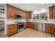 Modern kitchen featuring stainless steel appliances, wood cabinets, tile backsplash and marble countertops at 5326 Nw 76Th Ct, Ocala, FL 34482