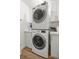 Conveniently arranged laundry area featuring stacked washer and dryer, and storage cabinets at 5326 Nw 76Th Ct, Ocala, FL 34482