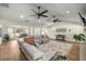 Open living area with vaulted ceilings, wood flooring, and modern furnishings; ideal for entertaining and relaxation at 5326 Nw 76Th Ct, Ocala, FL 34482
