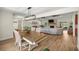 Open concept living and dining area with wood floors, stone fireplace and vaulted ceilings at 5326 Nw 76Th Ct, Ocala, FL 34482