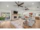 Bright living room features wood floors, a fireplace, and large sliding glass doors for natural light and outdoor access at 5326 Nw 76Th Ct, Ocala, FL 34482