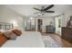 Spacious main bedroom with an elegant ceiling fan, wood flooring, and walk in closet at 5326 Nw 76Th Ct, Ocala, FL 34482
