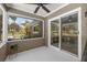 Comfortable screened-in porch with ceiling fan, sliding glass doors, and relaxing outdoor view at 5326 Nw 76Th Ct, Ocala, FL 34482