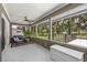 Relaxing screened-in porch with ceiling fan and views of the lush backyard at 5326 Nw 76Th Ct, Ocala, FL 34482