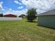 Expansive backyard featuring lush green lawn and tree, ideal for outdoor activities at 56 Walnut Dr, Ocala, FL 34480
