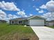 Charming single-story home showcasing a well-manicured lawn and a bright, welcoming facade at 56 Walnut Dr, Ocala, FL 34480