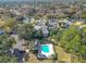 An aerial view of a community featuring a swimming pool with chairs and well-maintained landscaping around the buildings at 588 Fairways Ln # E204, Ocala, FL 34472