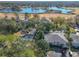Expansive aerial view of a lakeside community with lush trees and a community pool on the grounds at 588 Fairways Ln # E204, Ocala, FL 34472