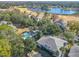 Aerial view of a community featuring a lake, pool, golf course and residences surrounded by trees at 588 Fairways Ln # E204, Ocala, FL 34472