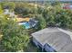 Gorgeous aerial view featuring a refreshing community pool, lush trees and golf course in the background at 588 Fairways Ln # E204, Ocala, FL 34472