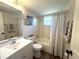 Bright bathroom featuring a shower-tub combination and a large mirror over the vanity with decorative elements at 588 Fairways Ln # E204, Ocala, FL 34472