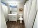 Bathroom featuring updated vanity, white cabinetry, and tiled shower at 588 Fairways Ln # E204, Ocala, FL 34472