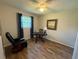 Cozy bedroom with wood-look floors and a comfortable chair, perfect for relaxing or reading in a quiet setting at 588 Fairways Ln # E204, Ocala, FL 34472