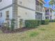 Exterior view of building showcasing well-maintained landscaping and pathways, blending seamlessly with nature at 588 Fairways Ln # E204, Ocala, FL 34472