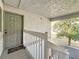 Exterior condo door and stairway with landing, offering a glimpse of the landscaped grounds at 588 Fairways Ln # E204, Ocala, FL 34472