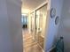 Hallway features mirrored closet doors, wood floors and neutral paint at 588 Fairways Ln # E204, Ocala, FL 34472