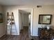 Hallway with wood-look flooring leads to a bedroom, and a modern cabinet complements the space at 588 Fairways Ln # E204, Ocala, FL 34472