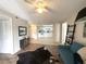 Inviting living room with modern décor, ceiling fan, and an open view into a bright, white kitchen at 588 Fairways Ln # E204, Ocala, FL 34472