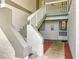 Exterior condo entryway with concrete steps leading to upper-level units and neatly maintained landscaping at 588 Fairways Ln # E204, Ocala, FL 34472