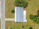 Aerial view showcasing the home's roof, driveway, and surrounding lawn in a serene residential neighborhood at 6263 Sw 107Th St, Ocala, FL 34476