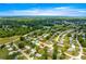 Wide aerial view of the property within a lush, green residential area, marked with a directional arrow at 6263 Sw 107Th St, Ocala, FL 34476