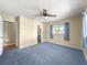 This is a carpeted bedroom featuring a ceiling fan and a window at 6263 Sw 107Th St, Ocala, FL 34476