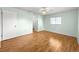 Bedroom with hardwood floors, neutral paint and windows overlooking the side yard at 6263 Sw 107Th St, Ocala, FL 34476