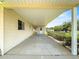 Attached carport with concrete flooring providing sheltered parking and entry to the home at 6263 Sw 107Th St, Ocala, FL 34476