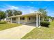 Ranch style home boasts mature trees and a covered entry to protect you from the elements at 6263 Sw 107Th St, Ocala, FL 34476