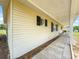 Charming home with light siding, black shutters, and a covered front entry with walkway at 6263 Sw 107Th St, Ocala, FL 34476