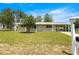 Charming single-story home with a covered entryway, well-maintained lawn, and mature trees in a sunny setting at 6263 Sw 107Th St, Ocala, FL 34476