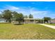 Charming single-story home boasts a well-maintained lawn, mature trees and a covered front entry at 6263 Sw 107Th St, Ocala, FL 34476