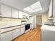 Kitchen with ample storage, white appliances, and pass-through to the living area at 6263 Sw 107Th St, Ocala, FL 34476