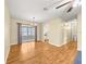 Bright living room boasts hardwood floors, neutral paint, and view to the kitchen at 6263 Sw 107Th St, Ocala, FL 34476