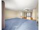 Spacious living room features plush carpeting, neutral paint, and view to the bright kitchen at 6263 Sw 107Th St, Ocala, FL 34476