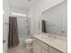 Clean bathroom featuring a shower and tub, vanity with counter space and tile flooring at 6342 Sw 77Th Ave, Ocala, FL 34474